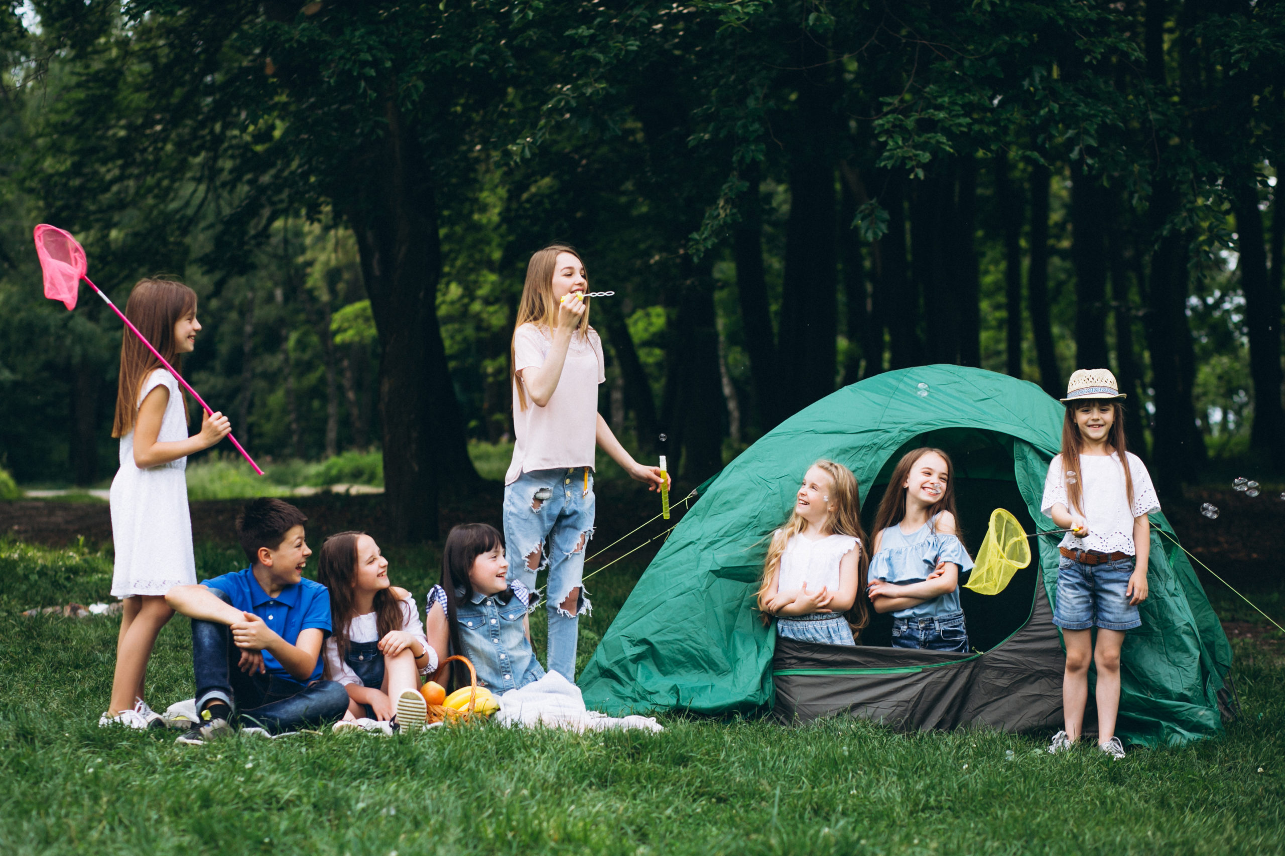 Group of teens camping in forest